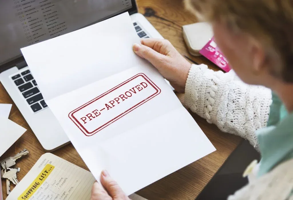 A home buyer reviewing a document marked pre-approved