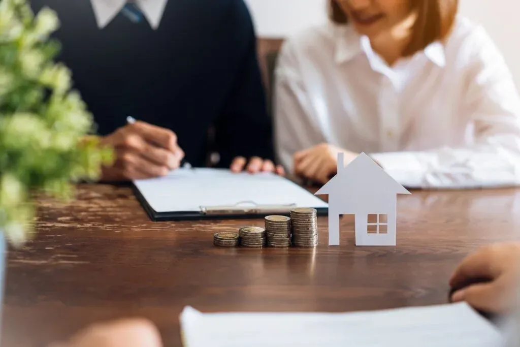 A couple discussing home loan documents with a lending adviser
