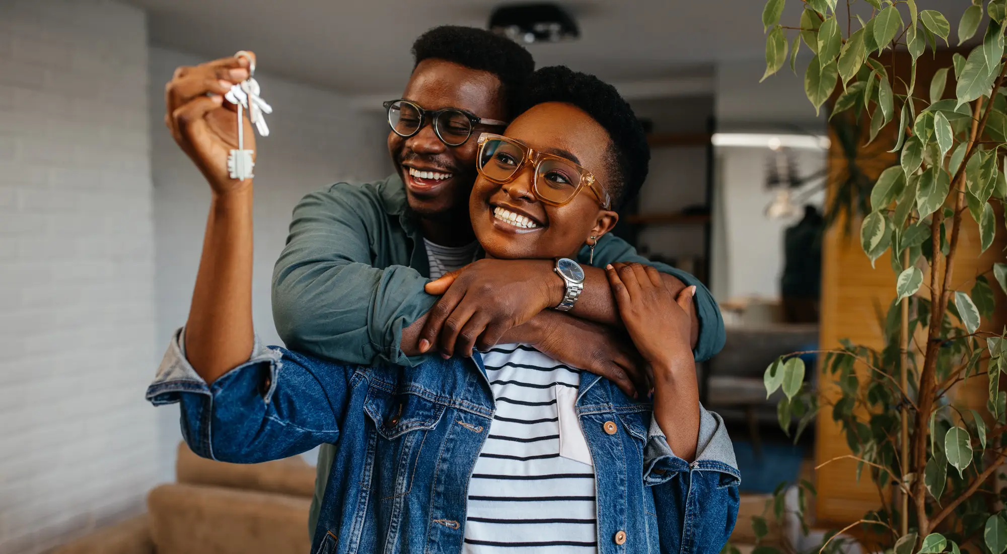 A smiling homeowner celebrating in her new home