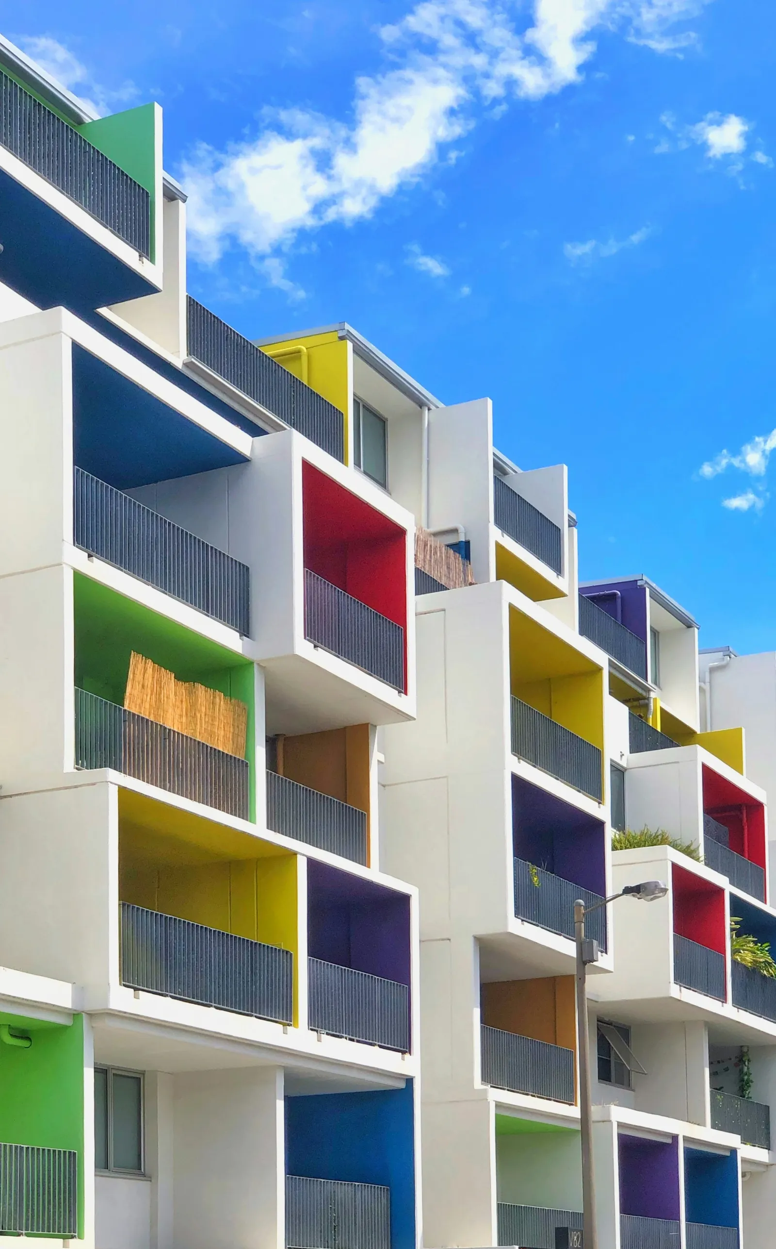 Brisbane apartment building with colourful balconies across several floors.