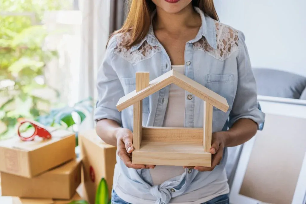 A home buyer holding a model house