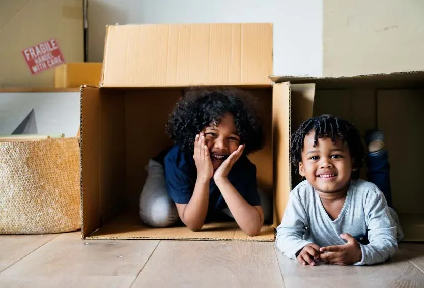 A parent and child unpacking after moving home