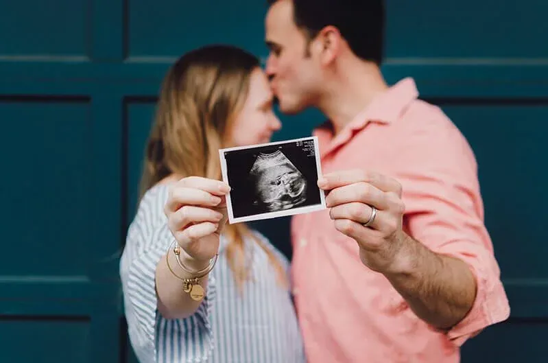 Expecting parents reviewing an ultrasound while planning their home loan