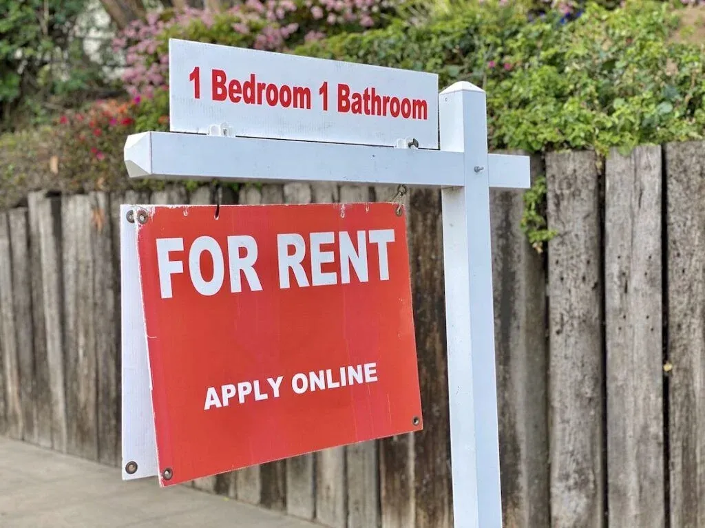 A sign advertising a residential property for rent