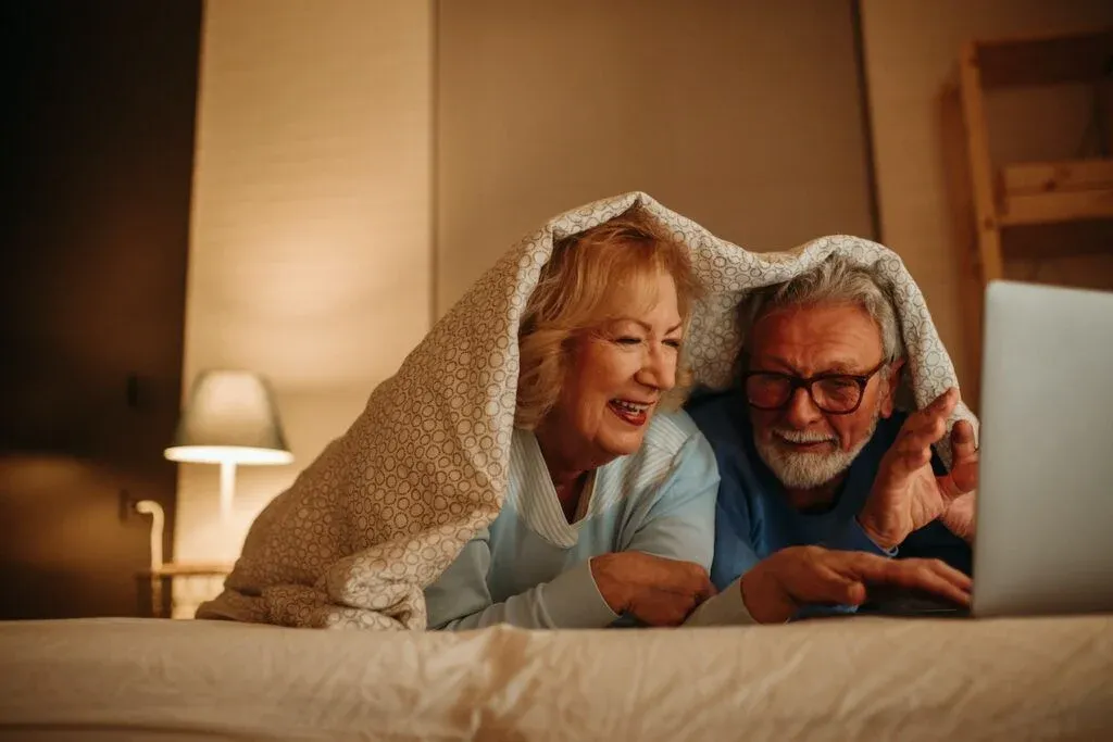 Older couple using a laptop together at home