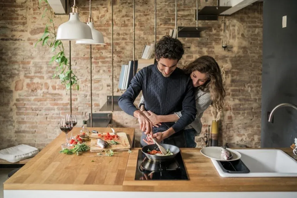 Couple preparing a meal in their rented home