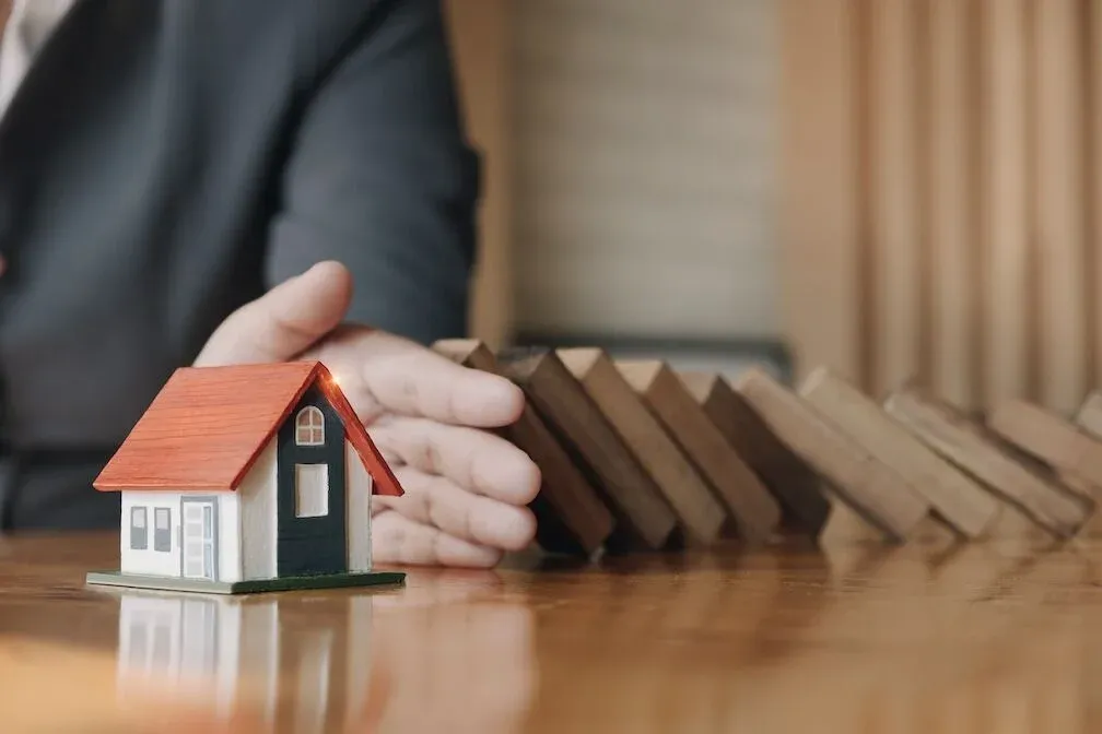 House model illustrating property ownership risk