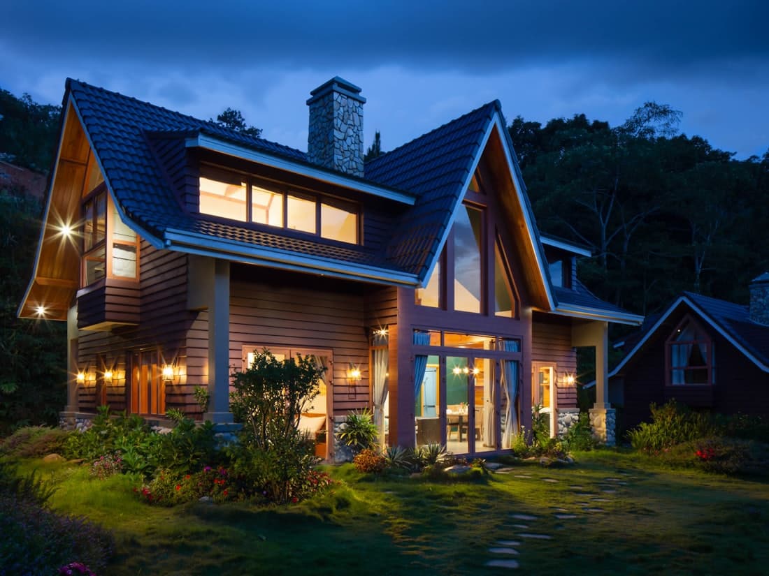 A warm, lit family home at dusk