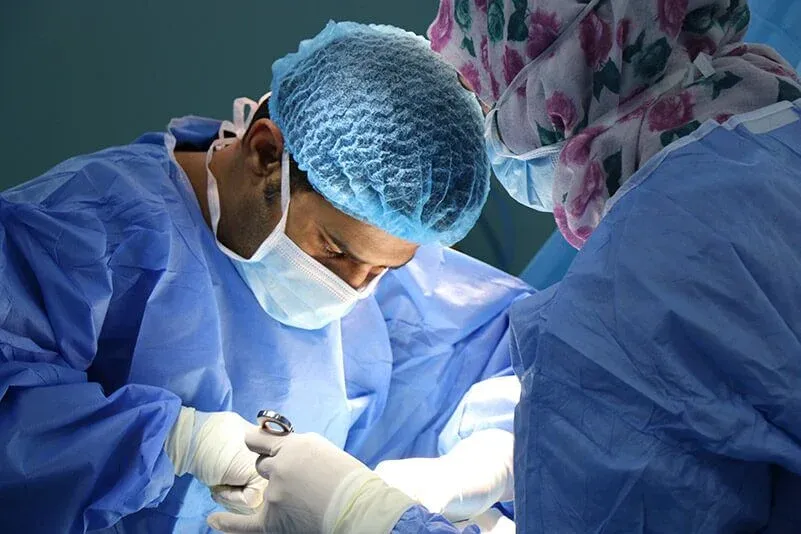 Two surgeons performing an operation in theatre