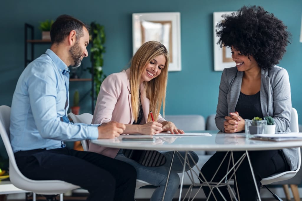 A couple considering the key factors when buying a home with a partner.